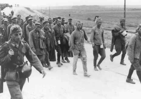 German soldiers guard Soviet prisoners of war marching to camps. Soviet Union, 1941